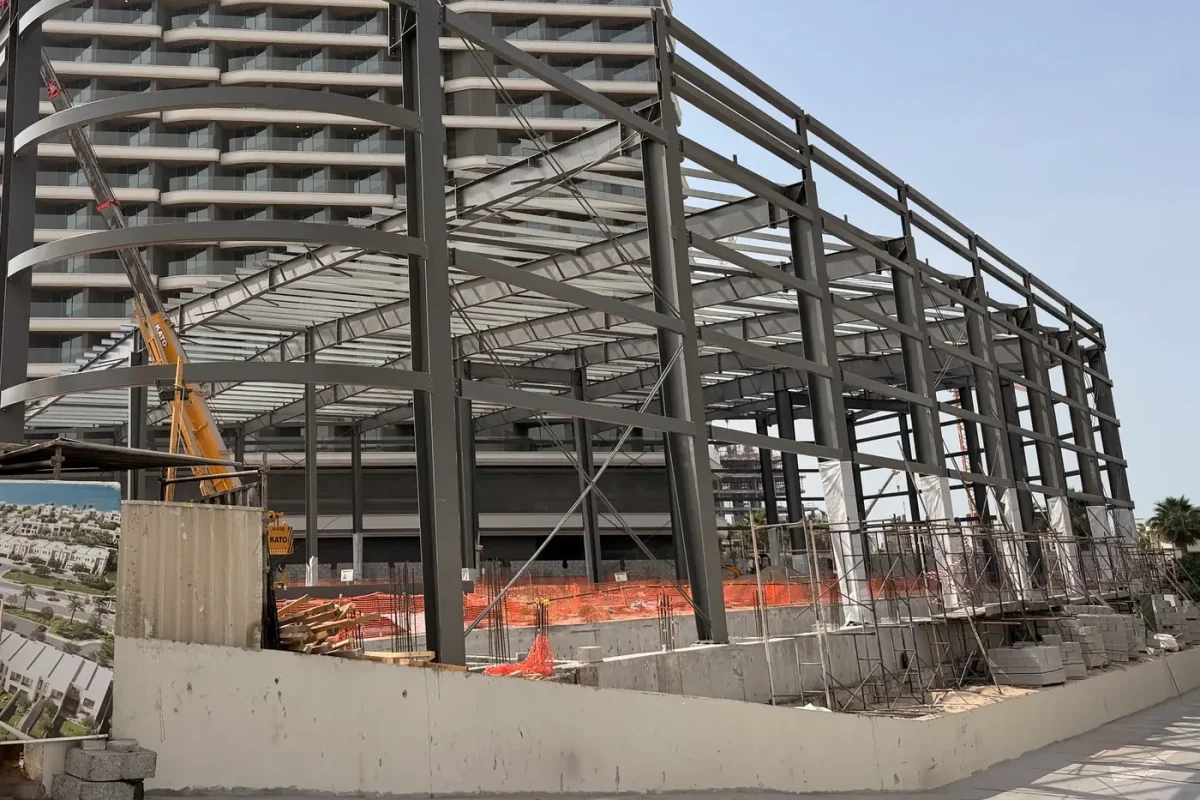 Steel portal frame of the covered parking bay, seen from the corniche
