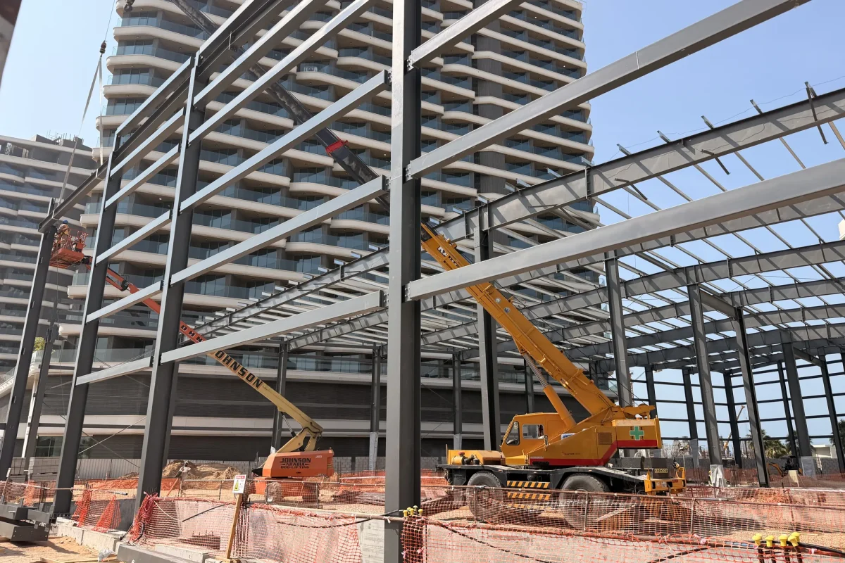 Mobile crane lifting a rafter into position